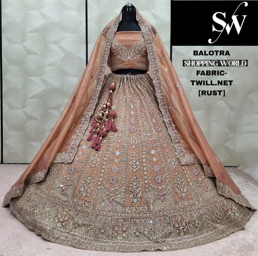 Astonishing Rust peach Twill net Lehenga