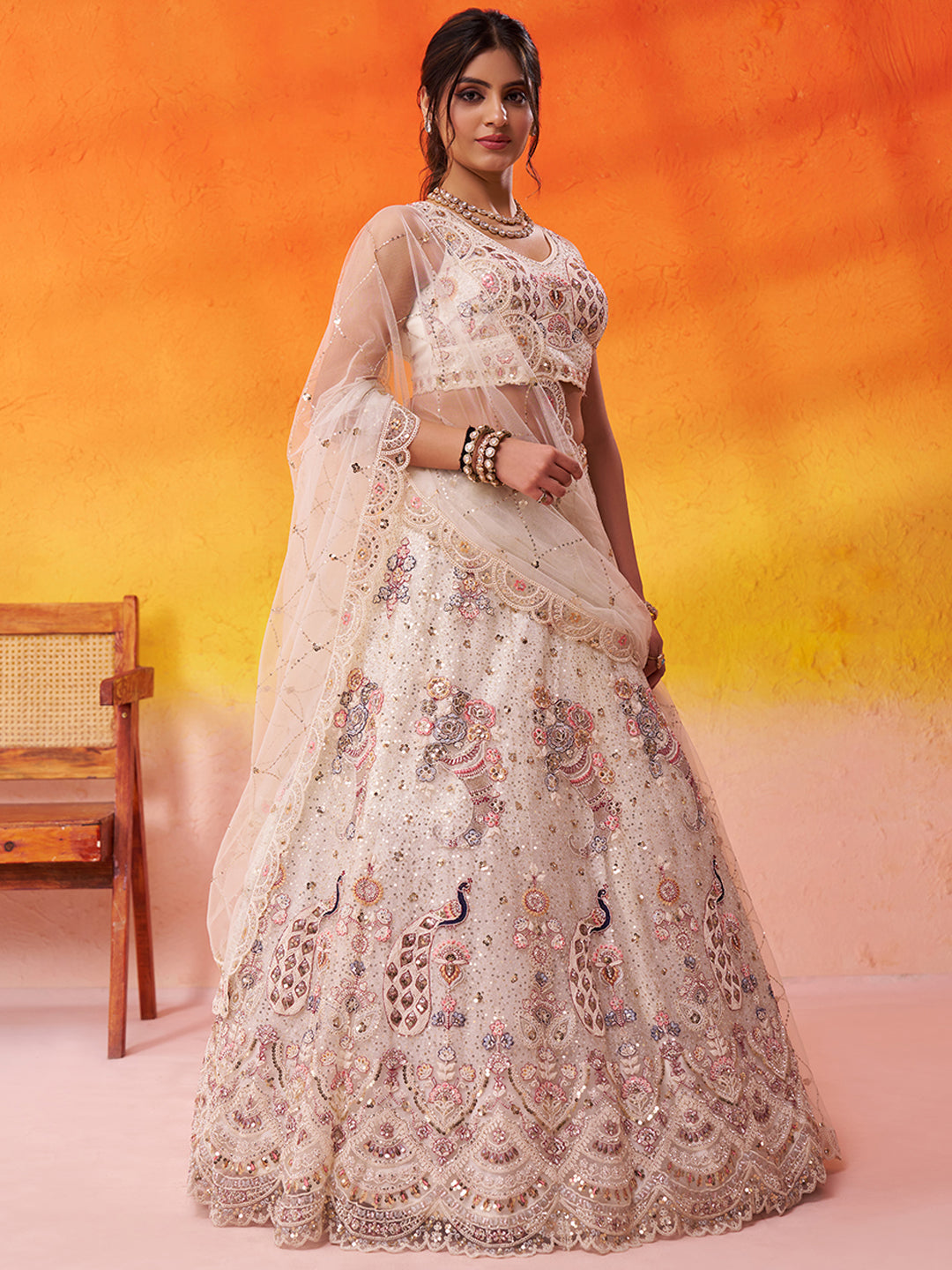 Tremendous Peacock Cream Net Fabric Sequins Lehenga 6246