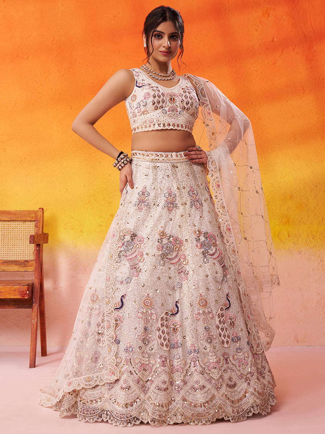 Tremendous Peacock Cream Net Fabric Sequins Lehenga 6246